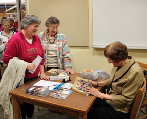 Wanda signing books for Iowa fans.